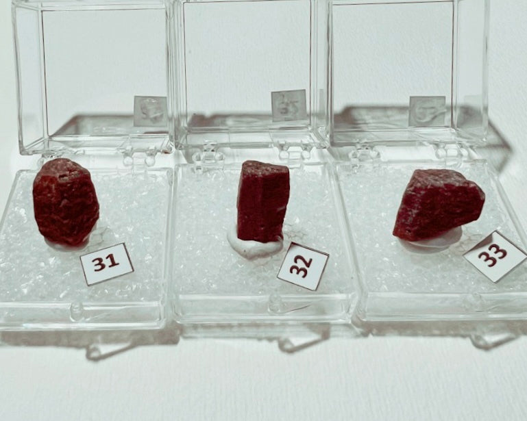 Ruby (Corundum) specimens in boxes