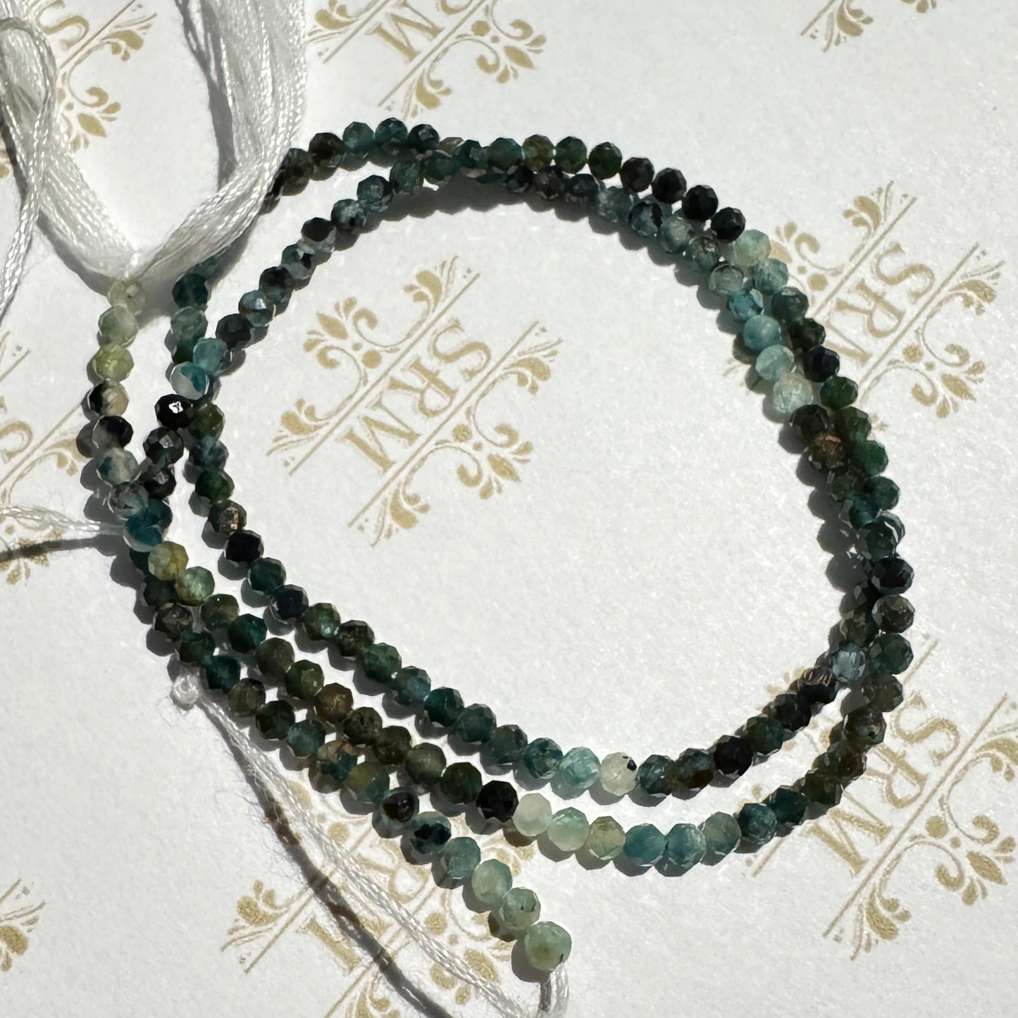 Faceted: Strand 2mm Grandidierite, 13", 14ct